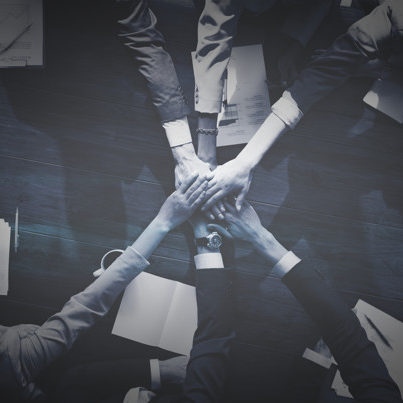 Business people stacking their hands Business people stacking their hands